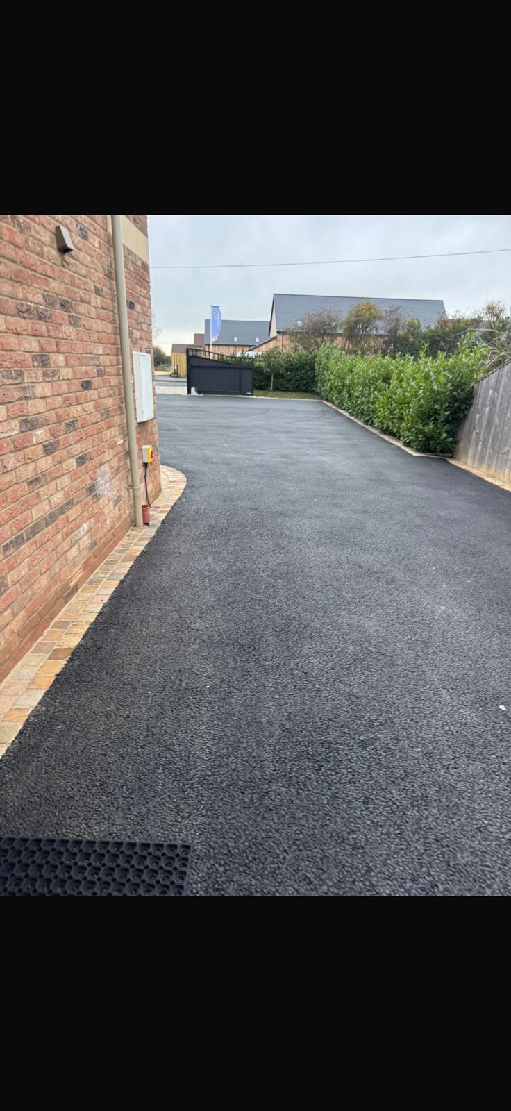 Fresh tarmac driveway after installation by H Driveways